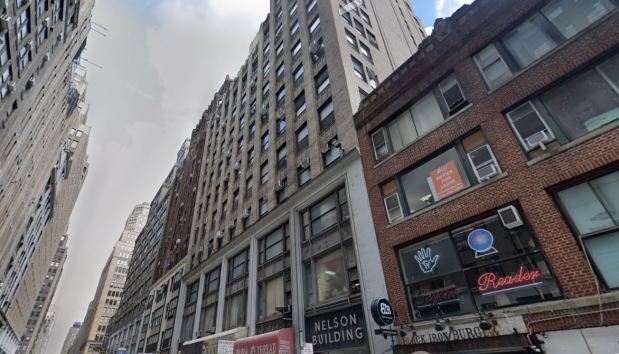 The victim rode the elevator with his tailor to the seventh floor of a building on W. 38 St. near Eighth Ave. about 1:15 p.m. Jan. 6, cops said. When they stepped off the elevator the victim was shot by a pair of crooks. (Google Maps)