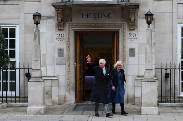 TOPSHOT - Britain's King Charles III (L) waves as he leaves, with Britain's Queen Camilla, the London Clinic, in London, on January 29, 2024. Britain's King Charles III, 75, stayed the London Clinic following prostate surgery on January 26, 2024. (Photo by Daniel LEAL / AFP) (Photo by DANIEL LEAL/AFP via Getty Images)